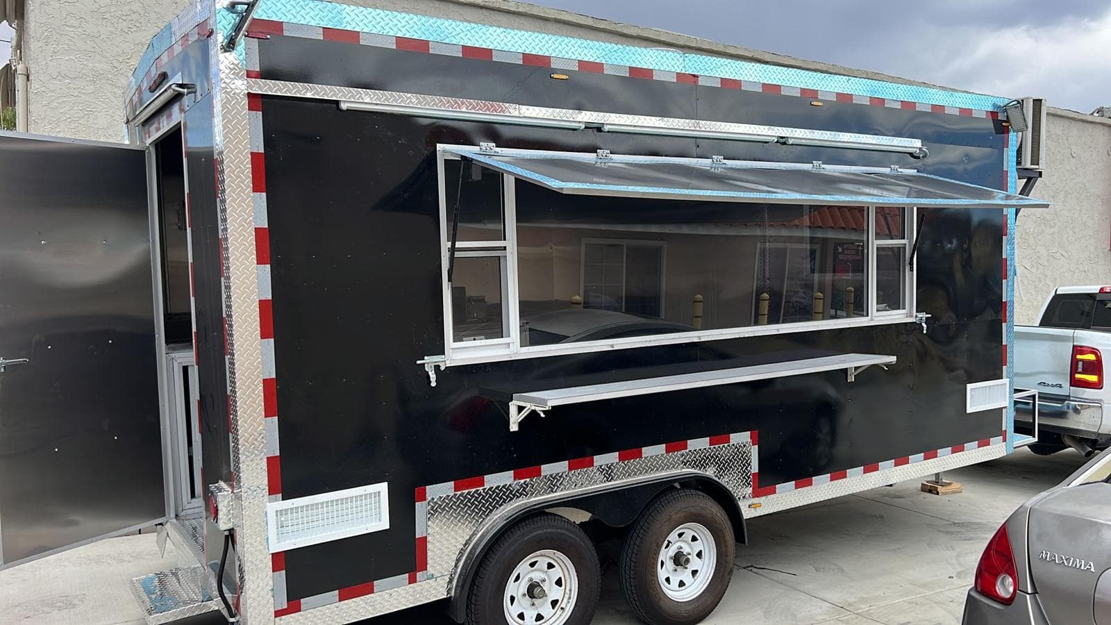 Open service window and fold-down counter on a finished food trailer